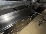 stainless steel counter tops and drawers in a commercial kitchen