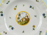 a plate with a picture of a man and a dog on it