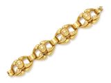 a yellow gold bracelet with an oval link