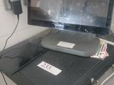 a computer monitor sitting on top of a desk next to a printer