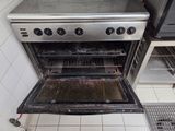 an oven that is open in a small kitchen