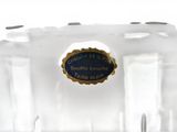 a clear glass vase with a blue label on it