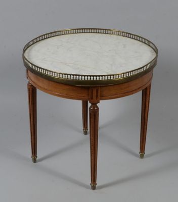 a round table with a marble top and wooden legs
