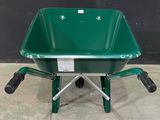 a green wheelbarrow that is sitting on the ground