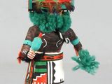 an image of a figurine of a native american man with feathers on his head
