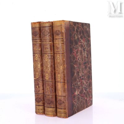 three books sitting on top of each other on a white surface