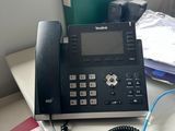 a telephone that is sitting on a desk next to a book