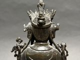 an image of a statue of a woman sitting on top of a table