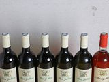 six bottles of wine are lined up in a row on a table