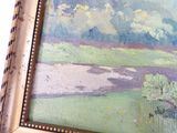 a picture of a painting of a landscape in a gold frame