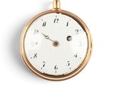 a gold pocket watch with a white face on a white background