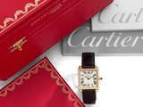 une boîte rouge sur laquelle est posée une montre, à côté d'une autre boîte rouge