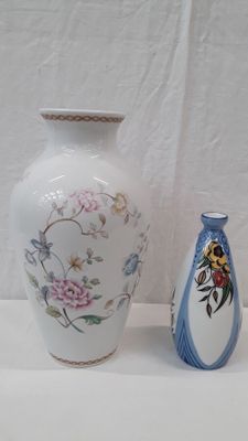 two vases sitting next to each other on a table