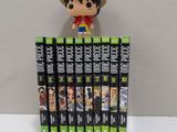 a small figurine of a man on top of a stack of dvds