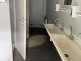 a bathroom with two sinks and a toilet in it