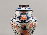 un vase muni d'un couvercle orné de fleurs