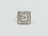 a close up of a diamond ring on a white surface