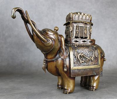 statue en laiton représentant un éléphant portant un panier sur le dos