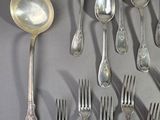 a lot of silver spoons and forks on the table