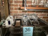 a display of glasses on a counter with a price tag