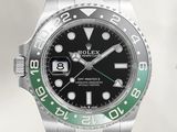a rolex watch with a black dial and green bezel