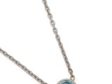 a necklace with a blue topaz stone is shown on a white background