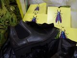 a pile of shoes and bags with bugs on them