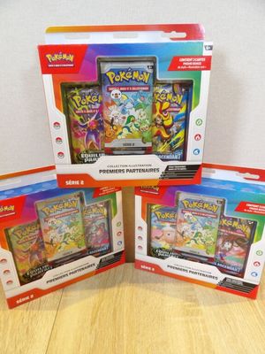 three packs of pokemon cards are sitting on a table