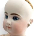 a close up of a doll with a headband on