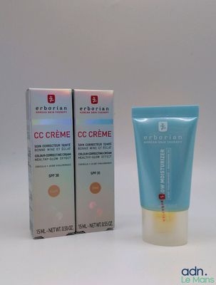 un gros plan d'un tube de crème à côté d'une boîte de crème