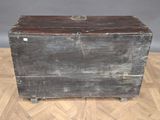 an old trunk sitting on a parquet floor