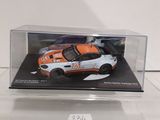 a white and orange car in a clear display case