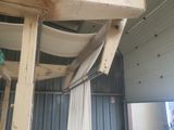 a picture of a room that has a ladder and a chair in it