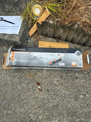 a box of tools sitting on the ground next to a plant
