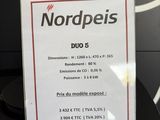 a sign that says nordpeis on it in front of a wall