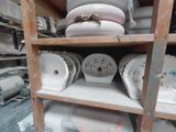 many plates and bowls on a shelf in a room
