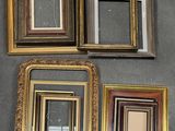 several different frames are arranged on a wall in a room