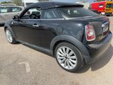a picture of a small black car parked in a parking lot