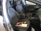 the interior of a car with the door open and the seats down