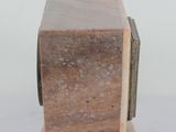 a small statue of a cat sitting on top of a wooden block