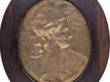 a picture of a bronze coin in a wooden frame
