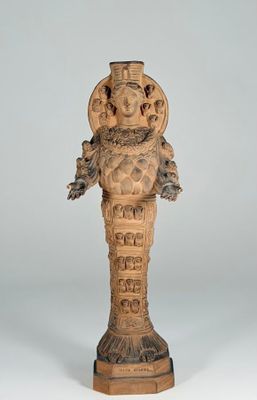 an image of a statue of a man with a bird on his head