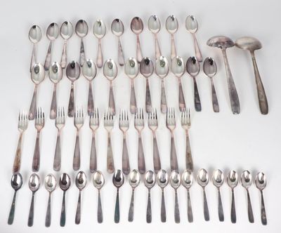 a lot of spoons and forks laid out on the table