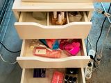 a drawer that has a lot of makeup and other items in it