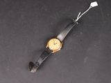 a close up of a wrist watch on a black surface