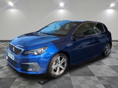 a blue car is parked in a room with a checkered floor