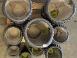 many cement pots sitting on a pallet in a warehouse