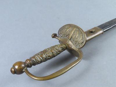 an image of a sword with a coin on the blade