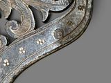 a silver metal wall decoration with a bird on it