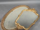 pair of antique gold framed mirrors on a gray surface